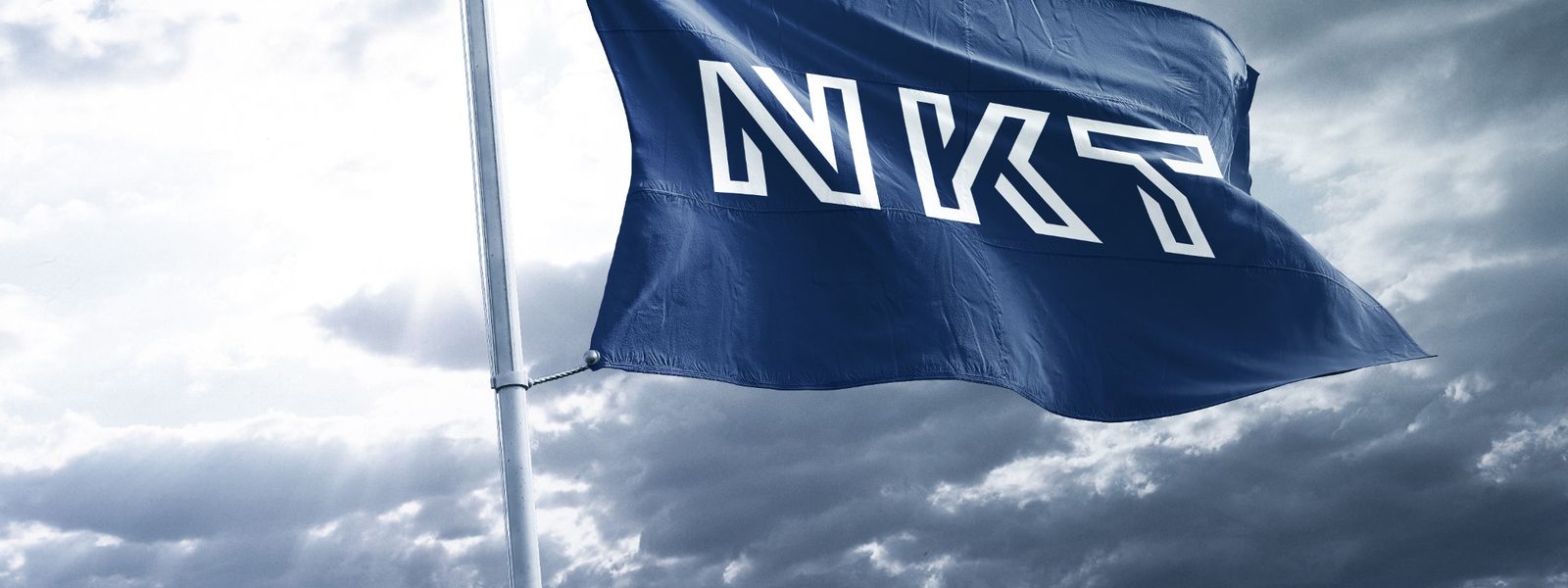 NKT flaf flying in the wind with grey sky